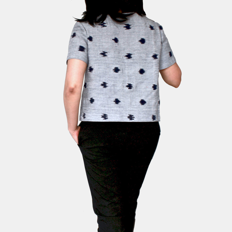 Back view of female model wearing Eden Crop Top in Ikat Cotton - Indigo Speckle