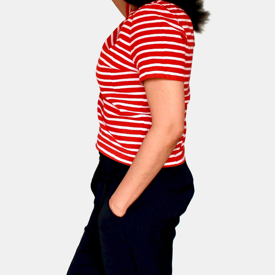 Side view of a female model wearing Eden Crop Top in Woodblock Print Cotton - Retro Red Stripes