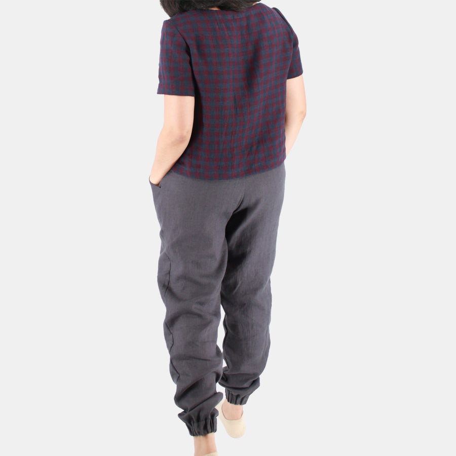 Back female model view of Womens Crop Top in Midweight Linen. Color of the top is autumnal or fall plum and navy checks