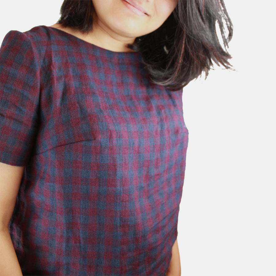 Side close up of Womens Top in Midweight Linen. Color of the top is autumnal or fall plum and navy checks